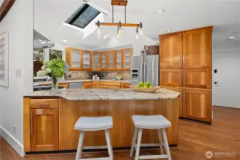 Thoughtfully designed kitchen with hardwood cabinets, solid countertops and stainless steel appliances.