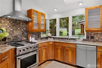 Stainless steel range and vent and great views to the pastures from the kitchen window.