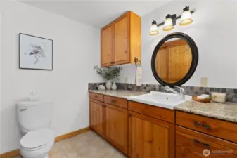 Half bath and storage around the corner from the kitchen.