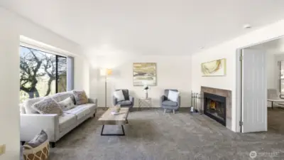 The living room offers the perfect ambiance with the natural light and the cozy fireplace.