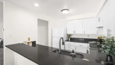 White shaker cabinetry, sleek countertops, undermount sink & all appliances stay.