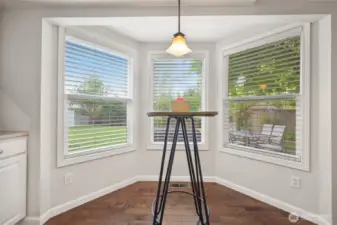 Off the kitchen this eating nook has lots of windows for view of backyard and tons of natural lighting