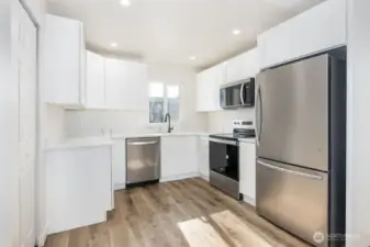 Light and bright kitchen with new cabinets and countertops.