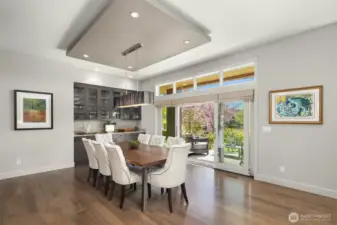 This generous dining area of the great room is perfect for both formal and informal dining.  The built in bar and doors to the front patio make entertaining a breeze!