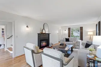 The spacious living room offers space for large scale furniture centered around a cozy fireplace.