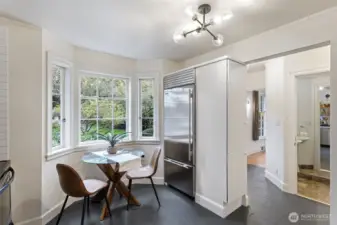 The eat-in kitchen features a bay window overlooking the beautifully landscaped yard.  It also has a convenient pantry.  Here you can see the guest bath just off the kitchen.