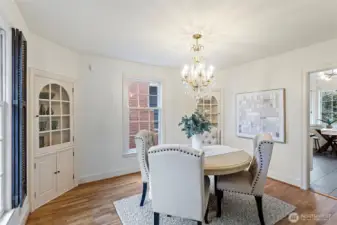 The dining room features an elegant crystal chandelier and corner cabinets for storing and displaying your favorite treasures.