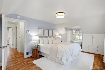 The primary bedroom has a peek-a-boo view of the sound, the perfect reading nook.