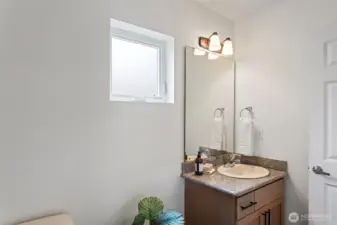 Half bath off the entry between the front door and the door to the attached garage.