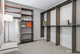 Primary dressing room with built in shelves