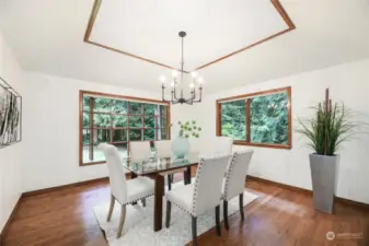 Formal dinning positioned close  to kitchen for ease of entertaining. Vaulted ceilings and wood wrapped window seat.