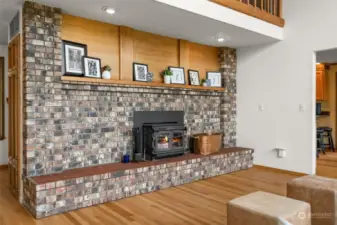 Beautiful brick and cedar surround wood burning fireplace.