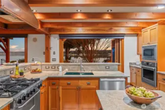 Kitchen has plenty of room for dual cooks - fir cabinetry, granite counters, Subzero refrigerator, Five Star 6-burner gas stove with broiler underneath, Miele dishwasher and built-in oven and microwave.  Plus, take a break and take in the scenery.