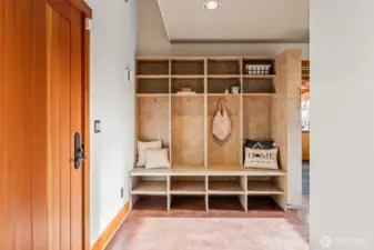 On the main level, the door on the left opens out to the front.  This is the mud/utility area and has lots of storage and useage. The flooring in this area and out to the garage is concrete.
