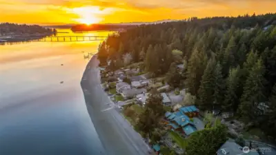 Welcome to the "Gold Coast", a choice beach for discerning buyers.  You can walk in either direction for miles.  Ahead is the Fox Island Bridge at sunset.