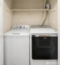 In-unit washer dryer in hallway to the right of front door