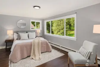 Upper-level guest suite with walk-in closet, western views, and beautiful natural light.