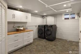 Lower level laundry room with ample area.