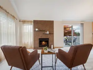 The large living room features a beautiful gas fireplace and large windows all around.