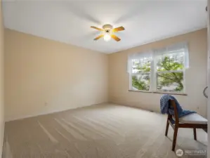 This bedroom features a wall of built-ins with a desk area.
