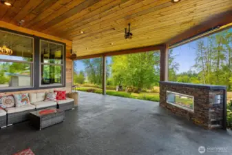 Massive covered porch with gas fireplace and movie projector.