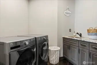 Generous mudroom off garage entry with utility sink.