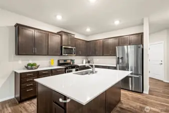 A central gathering point, the oversized quartz island is perfect for casual dining, meal prep, and hosting—creating the heart of the home