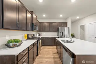 Showcasing abundant cabinetry, generous counter space, and a central island with built-in sink, this kitchen is designed for both style and practicality