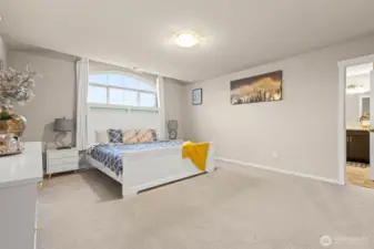 The inviting primary bedroom offers generous proportions, plush carpeting, and a seamless flow into the ensuite bath—your personal escape at the end of the day