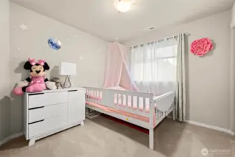 Upstairs bedroom offers ample space, natural light, and a generously sized closet for convenient storage