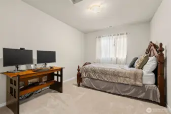 Spacious upstairs bedroom includes a large window and a full closet, perfect for everyday comfort or flexible use