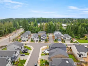 Enjoy the peaceful surroundings of this inviting neighborhood, nestled against a backdrop of evergreens with convenient access to nearby schools and shopping
