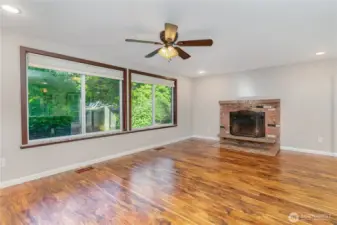 Another angle of the living room showing the large windows that fill the space with light