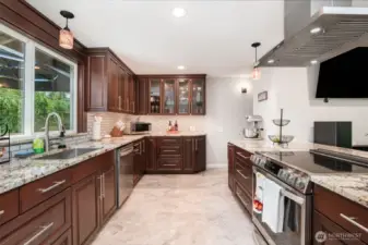 Ceiling-height kitchen cabinets with elegant window-style doors add both storage and style.