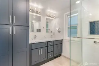 Elegant rich-toned cabinets for plenty for storage and dual sinks for modern convenience.