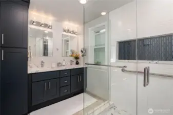 Elegant rich-toned cabinets for plenty for storage and dual sinks for modern convenience.