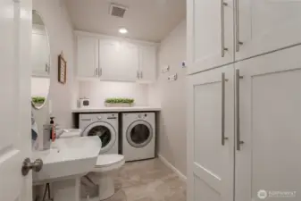 Convenient downstairs 1/2 bathroom connected to the laundry area, with washer and dryer included for your ease.