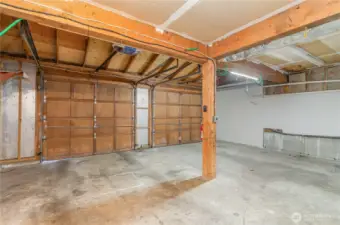 Large two-car garage features modern upgrades including generator readiness and an EV charger, offering both peace of mind and convenience.