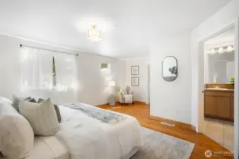 Primary suite with sitting area is designed for comfort and functionality.