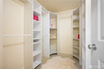 Walk-in closet with built-in custom closet system.
