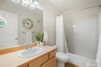 Full bath with tub/shower combo.