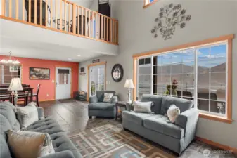 Main floor living room with view of loft
