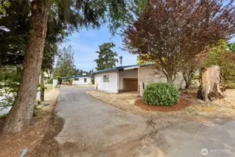 Lot is just shy of a 1/4 acre level.  Plenty of parking in the driveway, additional covered storage attached to the garage.