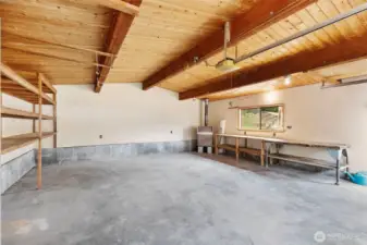 Large finished garage with storage and work benches.