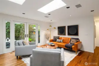 Living room attached to kitchen area, patio through french doors