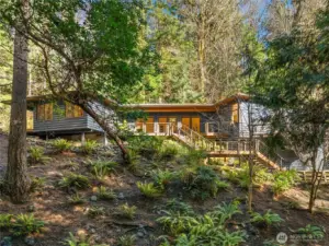 Welcome home to Crystal Springs Drive on the sunny south end of Bainbridge Island. This Pacific Northwest Contemporary home has three bedrooms plus an office and sits on 1.36 private acres.