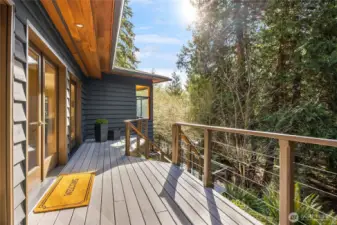 A sunny west-facing front deck is at your entry, in addition to a wall of glass that makes for a sunny and dramatic entrance.