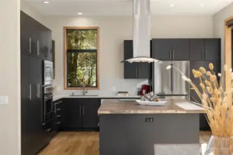 The spacious and open kitchen is well designed with updated appliances and quartz countertops.