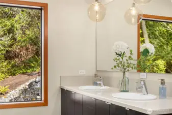 Back inside to the updated primary bathroom. This lovely room has dual sinks, an oversized walk-in shower, heated floors and modern fixtures and finishes.