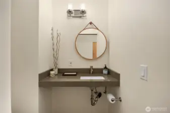 Adjacent to the home office is a half bathroom. Also freshly updated with modern finishes.